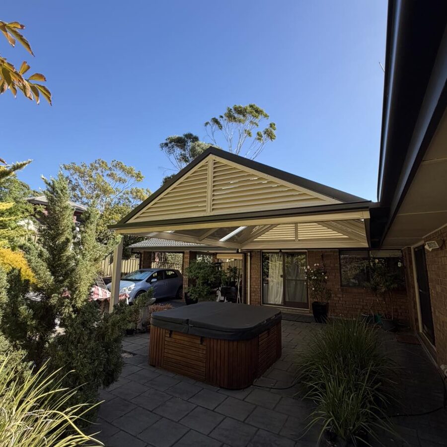 Gable veranda on brick house with carport