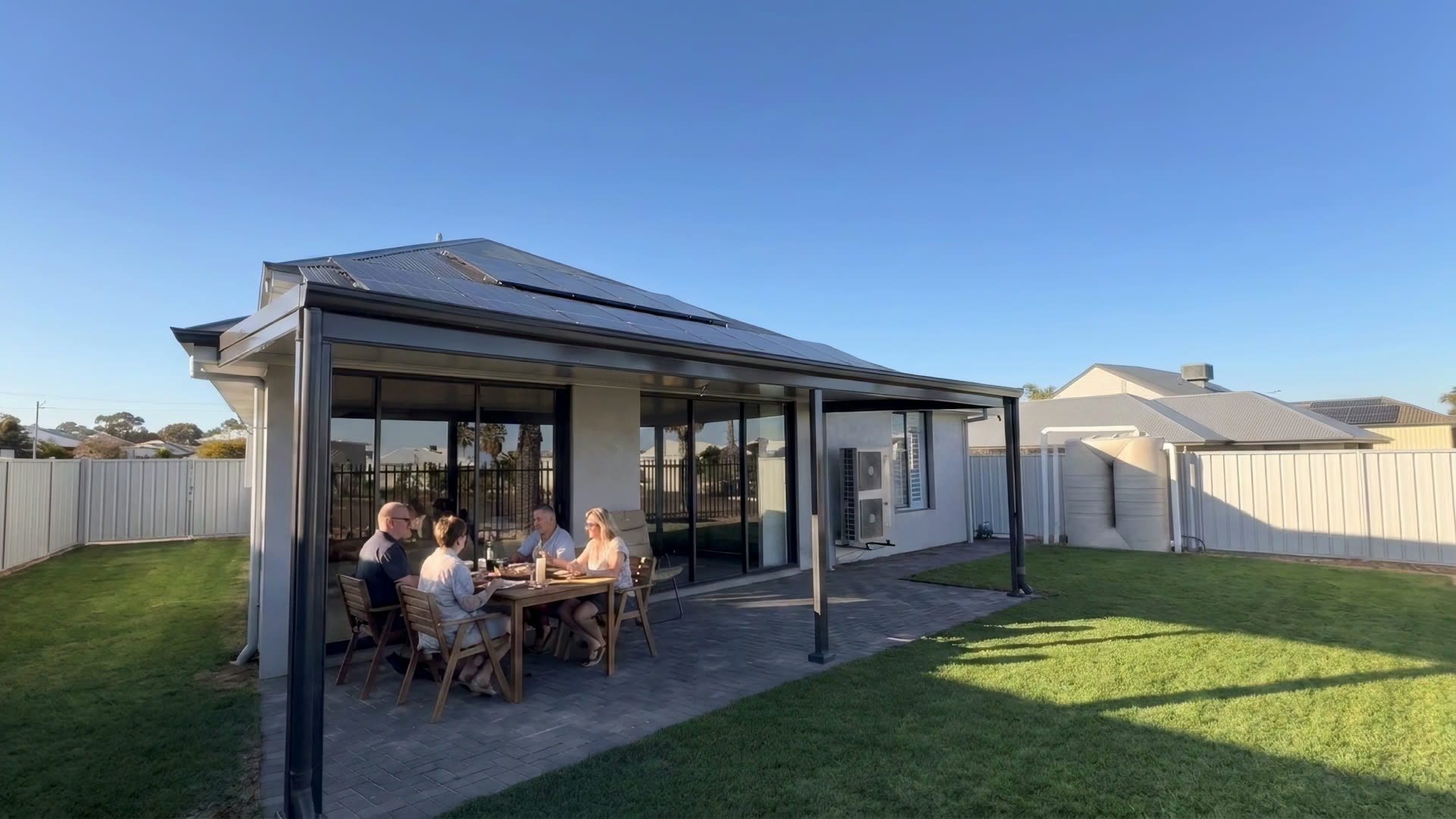 A verandah built onto an Adelaide home, finished with the family dining underneath by Flow Through Home Improvements