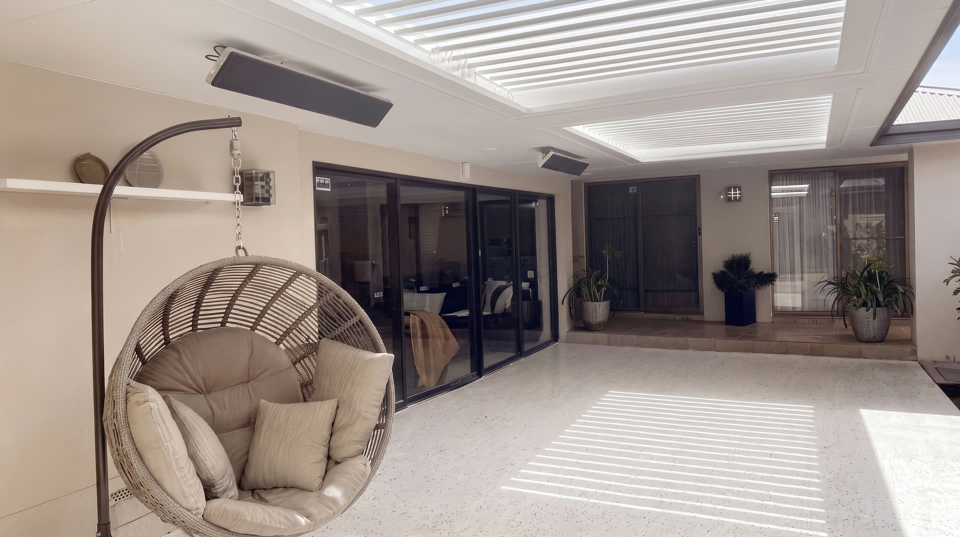 Louvred outdoor lounge with egg chair